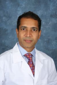 Dr. Ravi Singareddy a psychiatrist in white lab coat