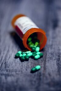 green pills falling out of bottle